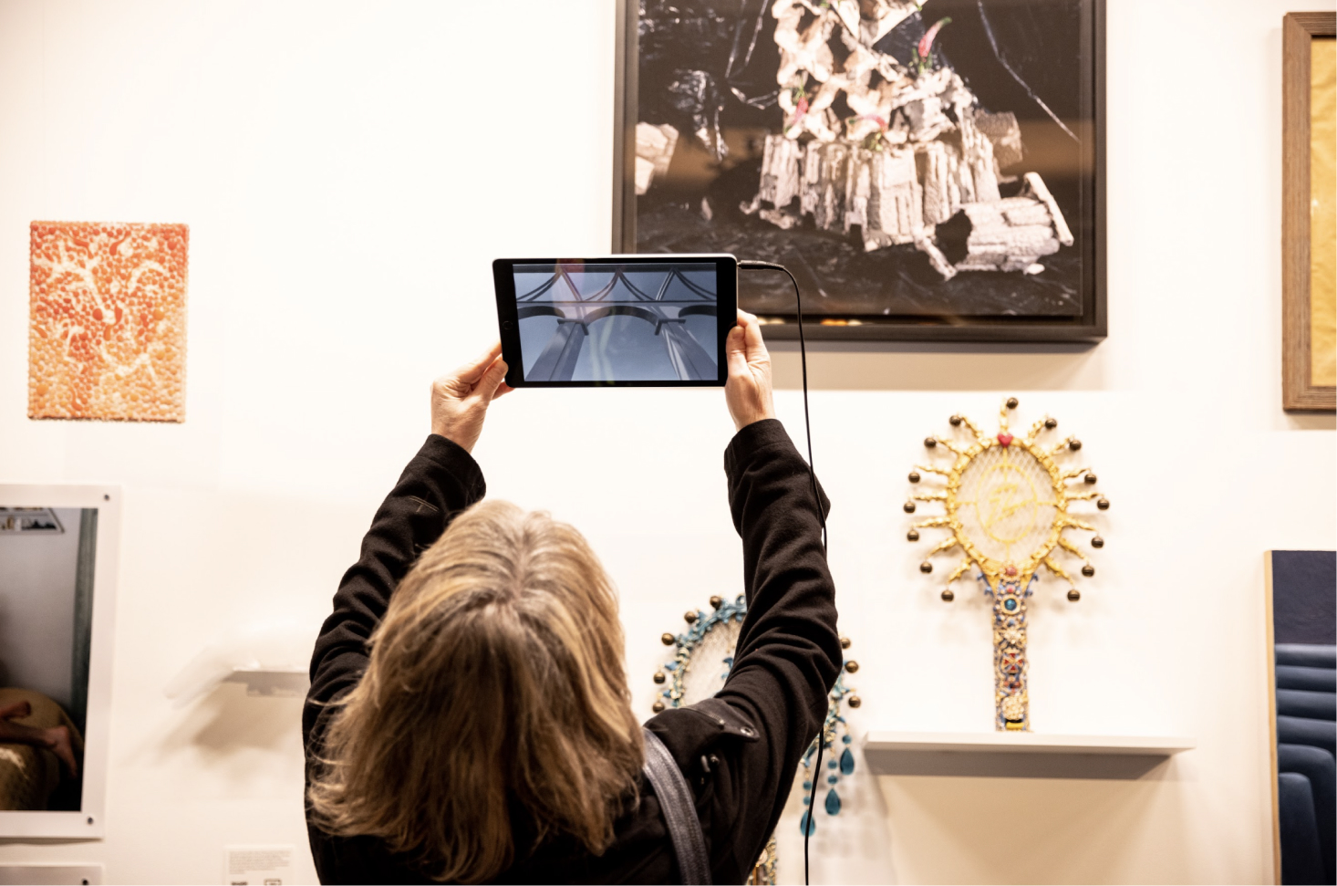 Photo of an individual taking a picture with their tablet