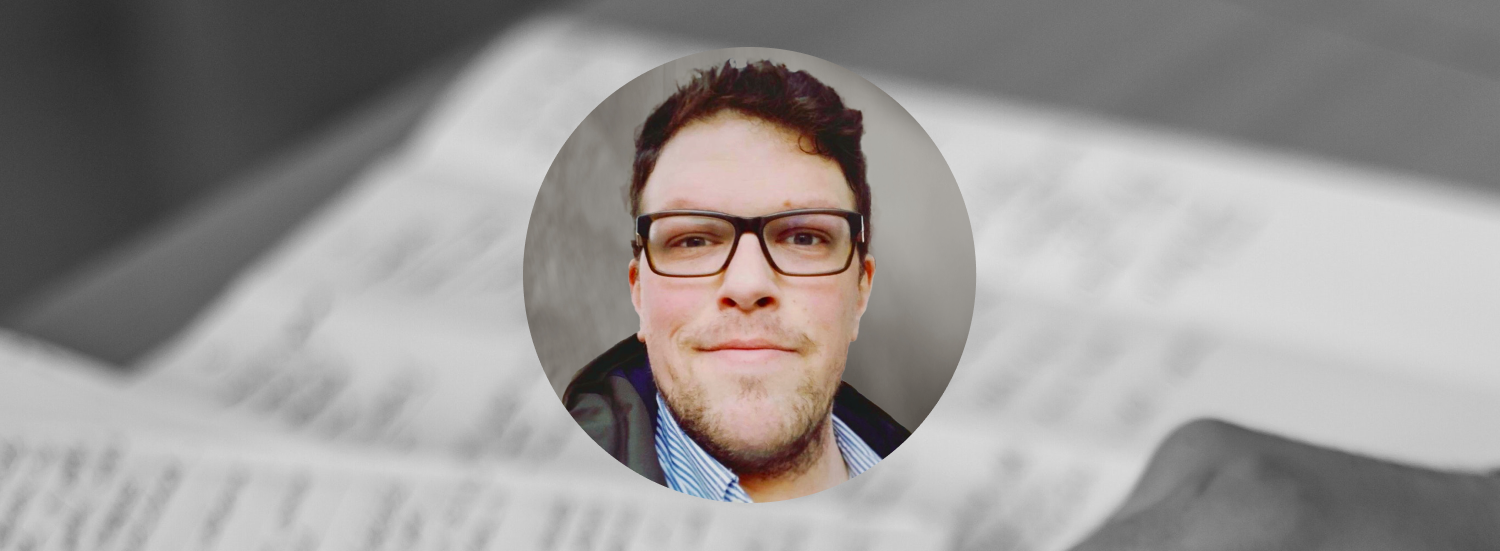 Circular cropped headshot of Ryan Hudak overlaid on a blurred black and white background of pages with writing on them.