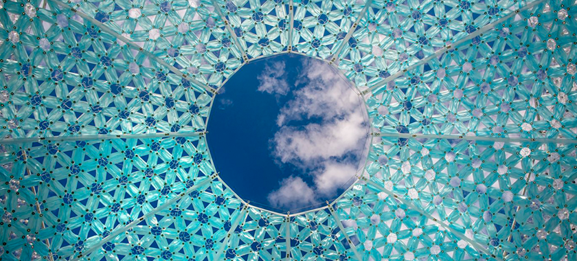 A circular picture of the sky with white clouds