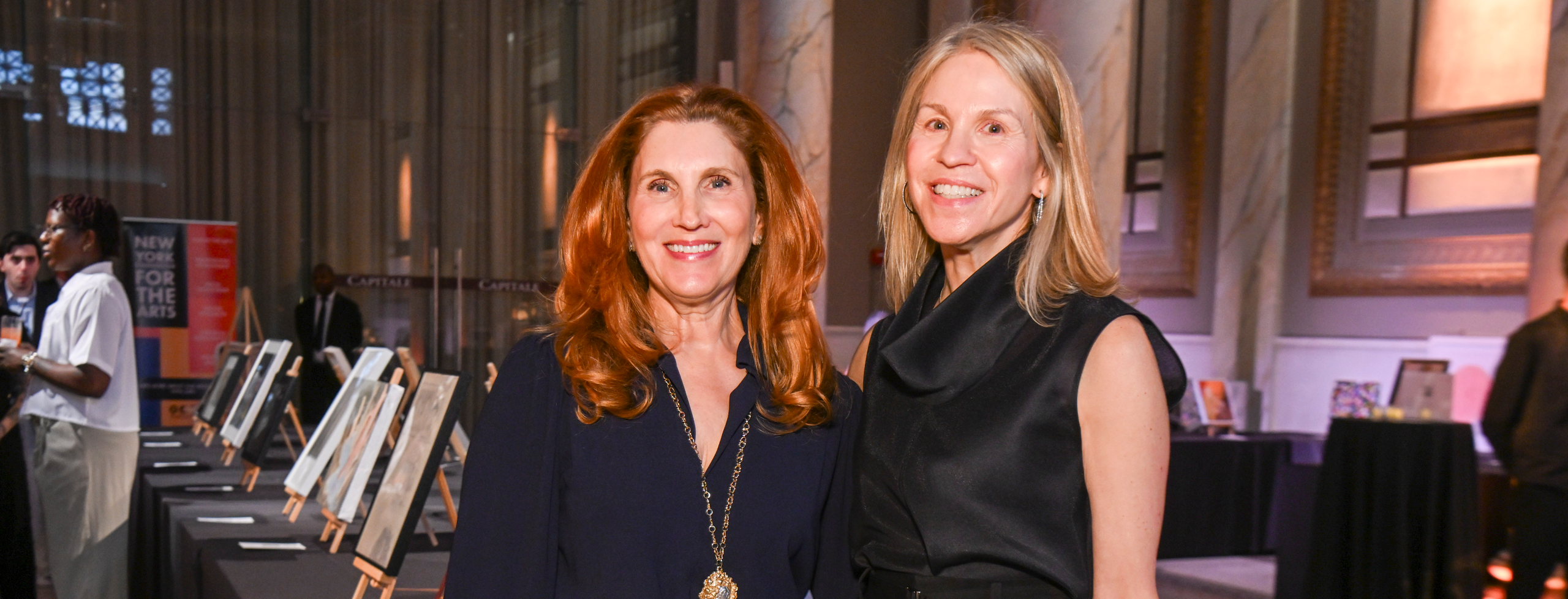 Lesley-Anne Gliedman and Sarah Young O’Donnell pictured in front of the auction artworks at NYFA's 2026 Hall of Fame Benefit